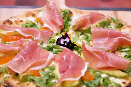 Pizza with prosciutto, cheese and arugulaの写真素材