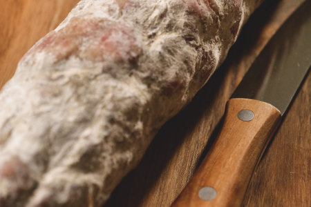 Close-up of bread with mold and knife on wooden cutting boardの写真素材