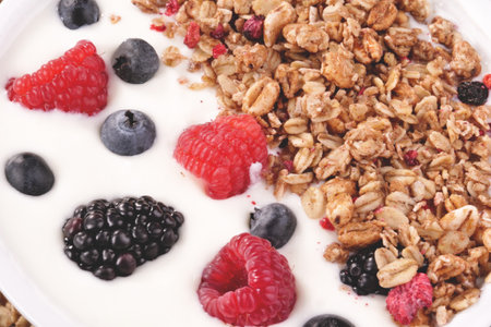 Granola with fresh berries and yogurt in a bowl close upの写真素材