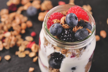 Healthy breakfast. Granola with yogurt, berries and muesli in glass jarの写真素材