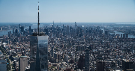 Aerial Photo with Top of the One World Trade Center Skyscraper with Antenna. Helicopter Flying Around the Glass Building with a View on Greater New York City Boroughsの写真素材