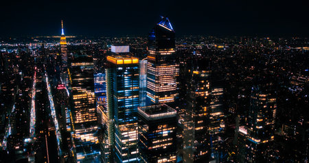 Helicopter Tour of New York City Architecture at Night. Manhattan with Panorama of Office Buildings with Lights and Congested Streets with Cars and Taxi Vehiclesの写真素材