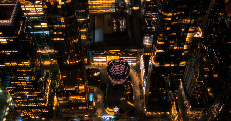 Helicopter Tour of New York Cityscape at Night. Manhattan with Panorama of Office Buildings with Lights and Congested Streets with Cars and Taxi Vehicles in a Big Cityの写真素材