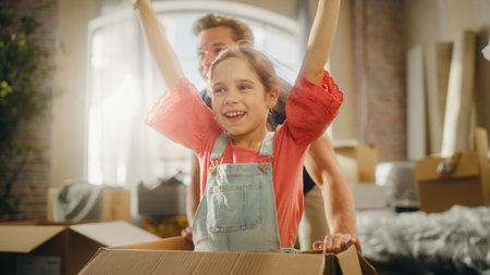 Moving in: Young Family of New Homeowners Has Fun. Father Driving Lovely Little Daughter in...