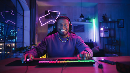 Gaming at Home: Satisfied African American Gamer Winning a Round in Online Video Game on Computer. Stylish Young Black Man Playing PvP Multiplayer Tournament. POV from Screen Perspective.の写真素材