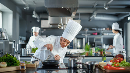 Restaurant Kitchen: Black Female Chef Cooking Delicious and Traditional Authentic Food, Uses Oil on...