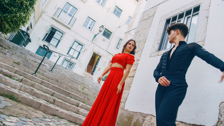 Beautiful Couple Dancing a Latin Dance on the Quiet Street of an Old Town in a City. Sensual Dance by Two Professional Dancers on a Sunny Day Outside in Ancient Culturally Rich Tourist Location.の写真素材