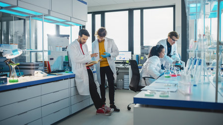 Modern Medicine Laboratory: Diverse Team of Multi-Ethnic Young Scientists Analysing Test Samples. Advanced Lab with High-Tech Equipment, Microbiology Researchers Design, Develop Drugs, Doing Researchの写真素材