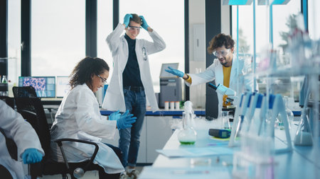 Medical Science University Laboratory Young Students Learning: Beautiful Black Scientist Made a Mistake and Has Mixed Chemical Liquids with Active Reaction, Her Colleagues Standing in Shock.の写真素材