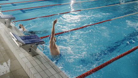 Successful Male Swimmer Celebrates New World Record and Championship Win with Raised Hand and...