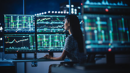 Financial Analyst Working on a Computer with Multi-Monitor Workstation with Real-Time Stocks,...