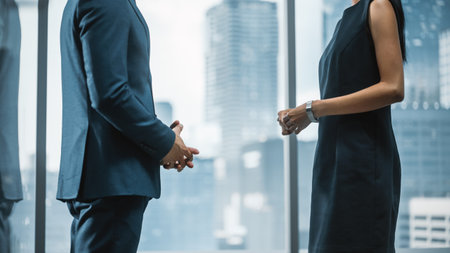 Female and Male Business Partners Meet in Office, Talk. Corporate CEO and Finance Manager Have Meeting in City Office. Businesspeople Discussing Real Estate Purchase and Marketing Project.の写真素材