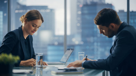 Female and Male Business Partners Sign Deal Documents in Meeting Room Office. Corporate CEO and...