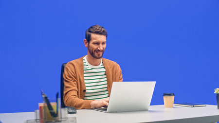Green Screen Office Background: Caucasian Businessman Sitting at His Desk Working on a Laptop...