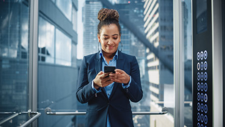 Confident Black Adult Female Riding Glass Elevator to Office in Modern Business Center. Successful...
