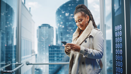 Successful Black Adult Female Riding Glass Elevator to Office in Modern Business Center. Beautiful...