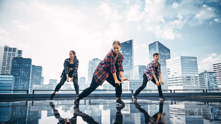 Diverse Group of Three Professional Dancers Performing a Hip Hop Dance Routine in Front of a Big Digital Led Wall Screen with Modern Urban Skylineの写真素材