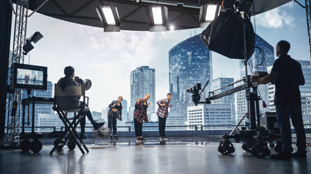 Music Clip Studio Set: Shooting Hip Hop Video Dance Scene with Three Professionals Dancers Performing on Stage with Big Led Screen with Modern Cityの写真素材