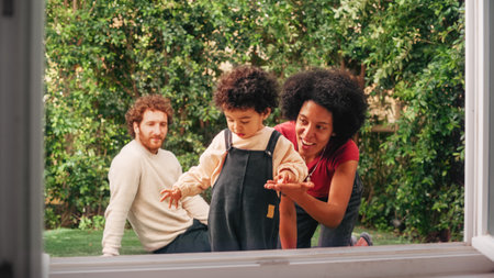 Loving Mixed Race Family Playing with Adorable Baby Boy at Modern Home, Hanging in the Garden. Cheerful Mother Nurturing a Child. Concept of Childhoodの写真素材