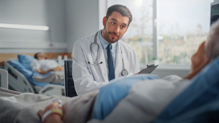 Hospital Ward: Friendly Doctor Talks to Beautiful Senior Female Patient Resting in Bed, Explains Test Results, Gives Recovery Advice. Physician Talksの写真素材