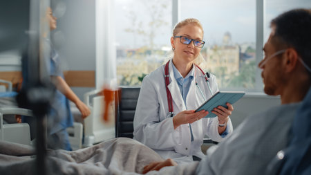 Hospital Ward: Resting in Bed Caucasian Male Patient Listens to Experienced Female Doctor Explaining Test Results, Gives Advice, Used Tablet Computerの写真素材
