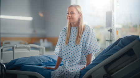 Modern Hospital Ward: Beautiful Caucasian Female Patient Resting on a Bed, Fully Recovering after Successful Surgery, Sickness or Coronavirus sheの写真素材