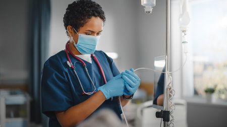 Hospital Ward: Professional Black Head Nurse Wearing Face Mask Does Checkup of Patients Vitals, Checking Heart Rate Computer, Intravenous or Ivの写真素材