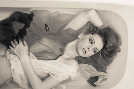 blond elegant young pinup lady with silk skin, excellent blond hair, mouth open in pleasure having...