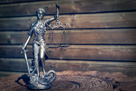 sculpture of themis, femida or justice goddess on wood lining backgroundの写真素材
