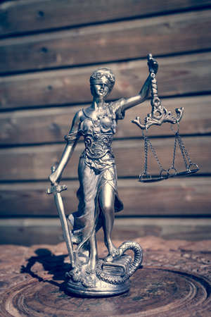 sculpture of themis, femida or justice goddess on wood lining copyspace backgroundの写真素材