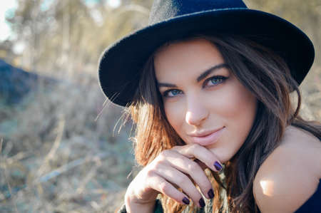 elegant pretty girl having fun joyfully looking at camera & happy smiling on autumn copy space outdoors background, closeup portraitの写真素材