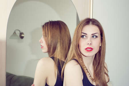 portrait of beautiful blonde romantic young woman sitting relaxing on mirror copy space backgroundの写真素材