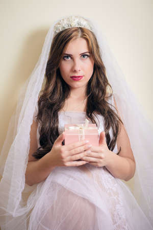 portrait of beautiful young princess holding present boxの写真素材