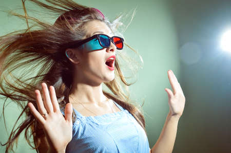 Picture of surprised young pretty lady in 3d glasses looking amazedの写真素材