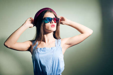 Girl in 3d glasses thoughtfully lookingの写真素材