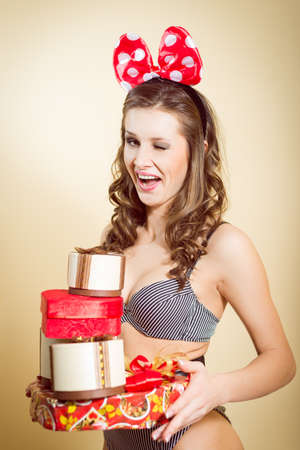 Portrait of romantic sexy young pretty lady having fun emotionally enjoying presents on light copy space backgroundの写真素材