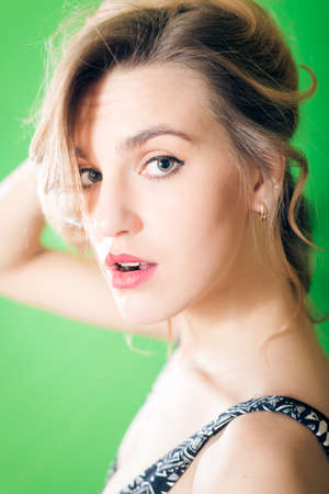Portrait closeup of beautiful young blond woman in lingerie happy looking at cameraの写真素材