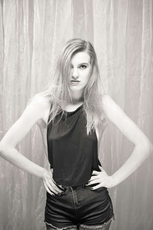 Black and white portrait of beautiful young sexy woman on light backgroundの写真素材