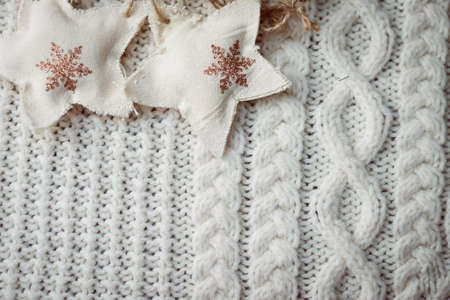 Image of handmade knitted pattern and couple of decorative stars