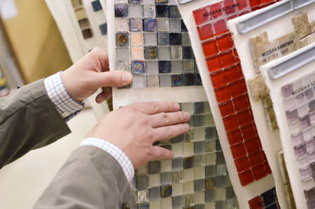 Closeup picture on hands choosing or presenting colorful samples