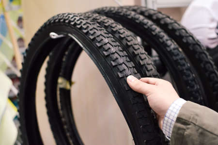 Closeup picture on hand choosing or presenting cycle spare tire
