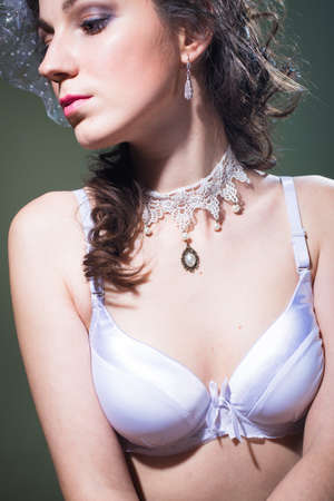 Close up portrait of beautiful young lady in bra and pearl necklaceの写真素材