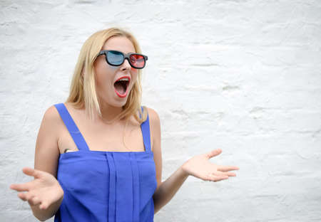 Portrait of young amazing beautiful lady in 3d glasses surprising and screaming. Excited girl in...