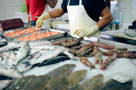 Picture of store tray with seafood. Closeup of prawns, shrimps and fish on market indoor background.の写真素材