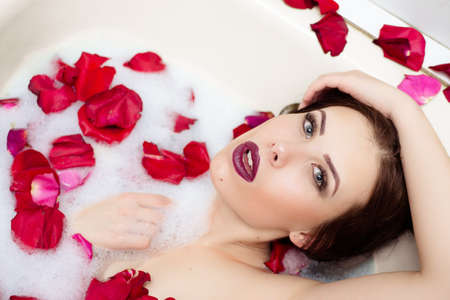 Portrait of elegant sexy pretty girl with silk skin having fun laying in water bath relaxing on copy...