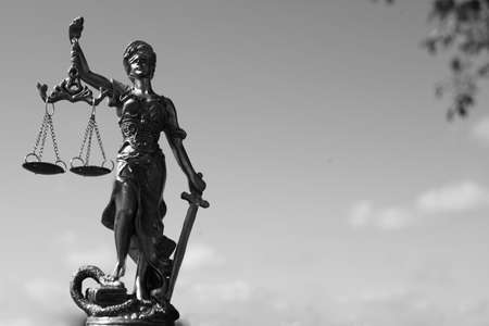 Themis, femida or justice goddess on bright blue sky copy space background. Black and white photographyの写真素材