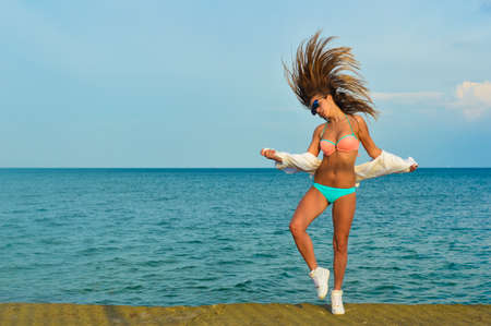 Picture of beautiful young woman enjoying dancing over outdoors copy space backgroundの写真素材