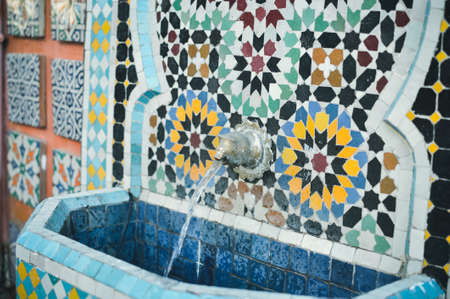 Photo of Moroccan street fountain with beautiful traditional floral ceramic tile mosaicの写真素材