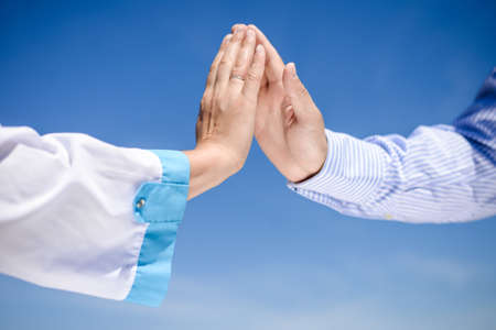 Picture of doctor or scientist hand touching someone's hand with care. Closeup of medicine support...