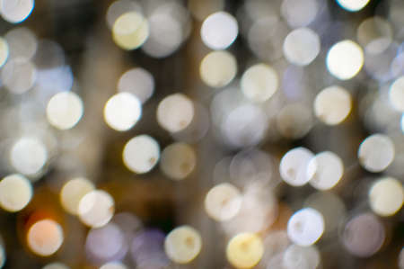 Picture of light blurred background with white bokeh lights on it. Festive holiday theme with copyspaceの写真素材